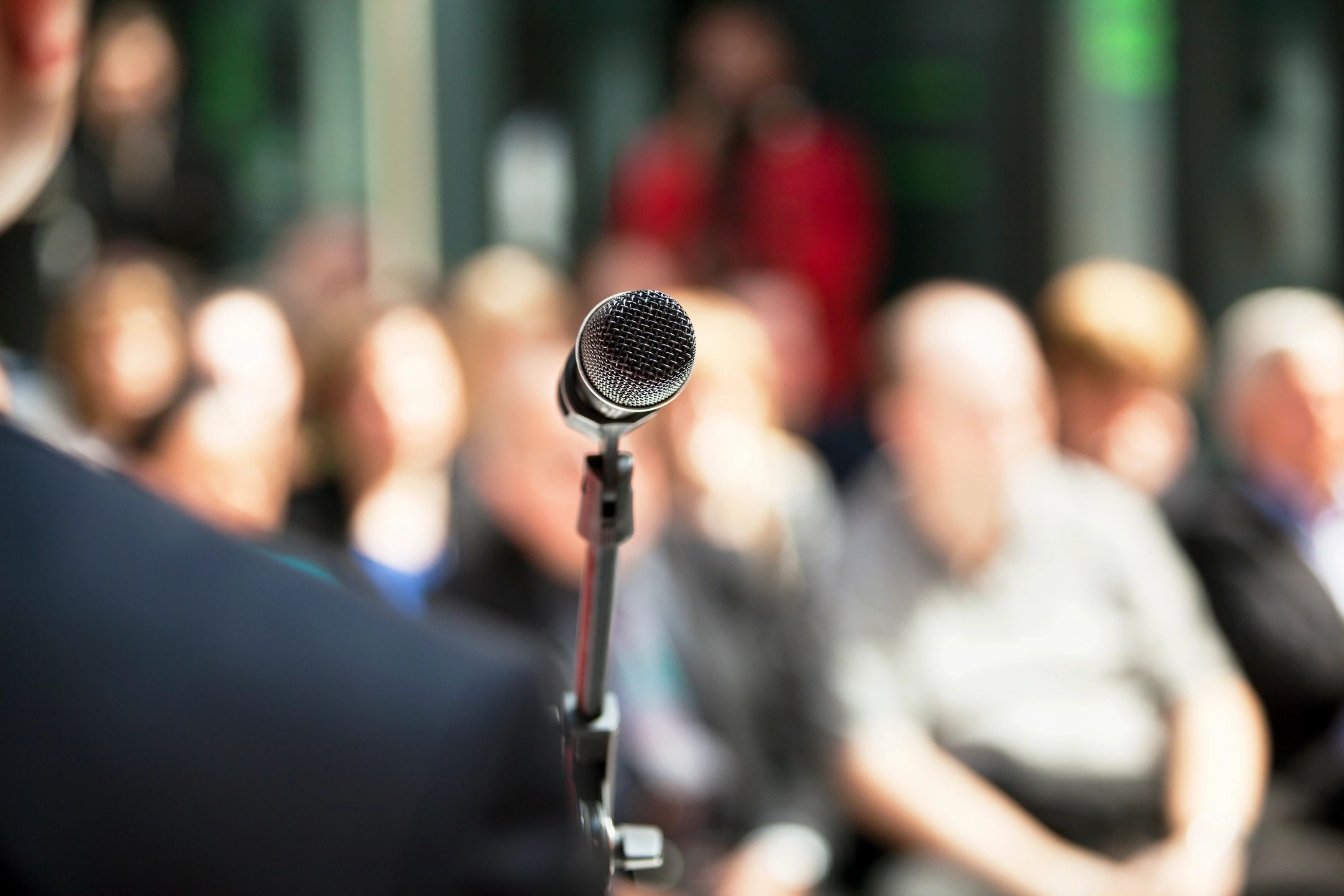 A microphone with burred people
