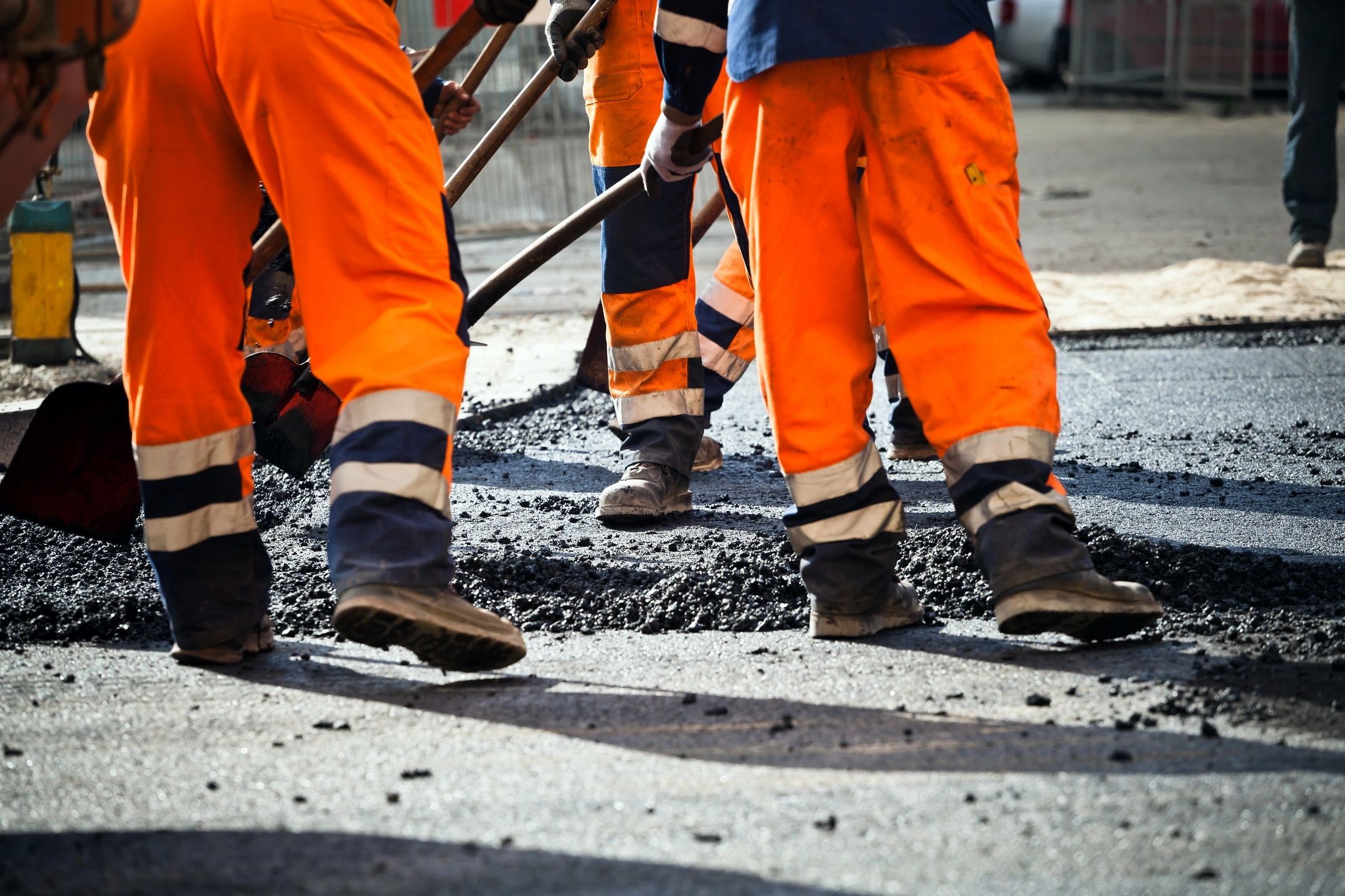 road workers paving road